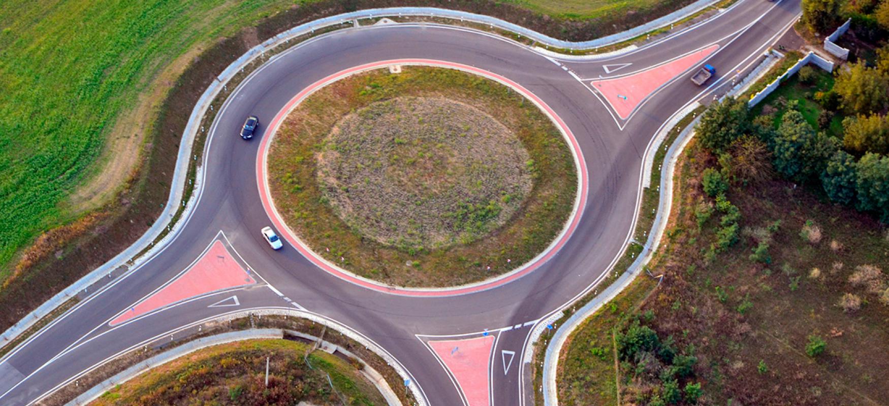 Photo of a three-armed roundabout with cars driving from above