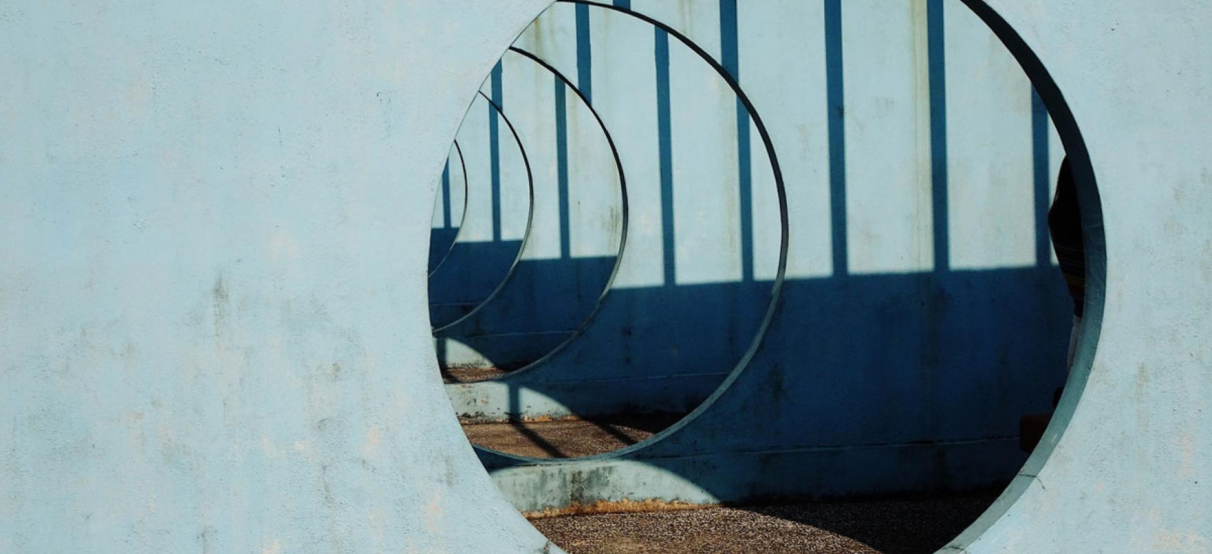 Circular hole in concrete wall.
