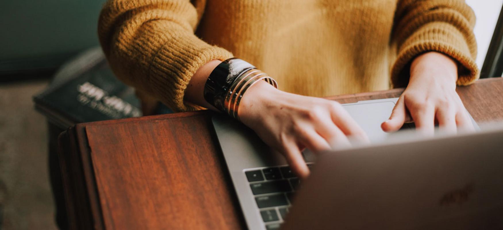 Woman sitting in front of a laptop