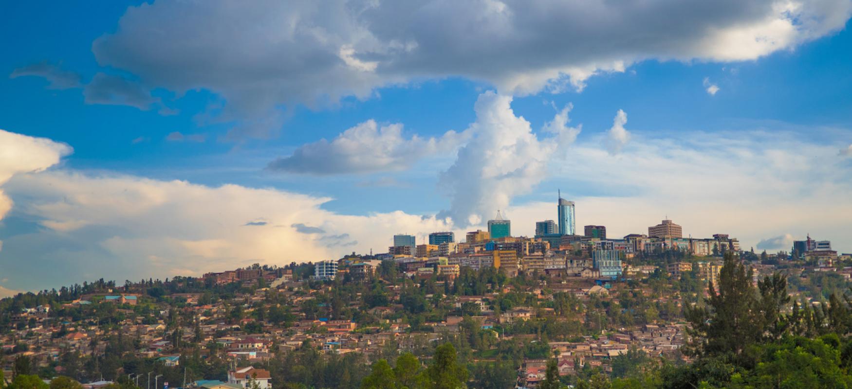 Overview of Kigali, Rwanda with the city skyline. Blue skies with some white clouds can be seen in the top half of the picture.