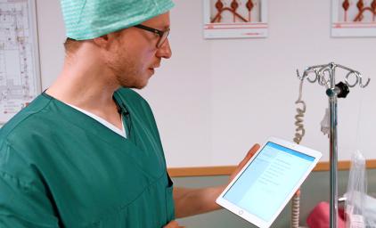 Doctor looking at tablet.