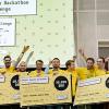 Group of people cheering and holding prize checks