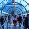 People in a train station glass walkway in Chongqing, China