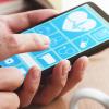 Mobile phone with health data apps on the screen held by a man