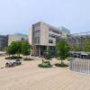 University of Copenhagen Southern Campus. A modern building and open space with trees.