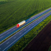 Birdzs view of red truck driving across green fields